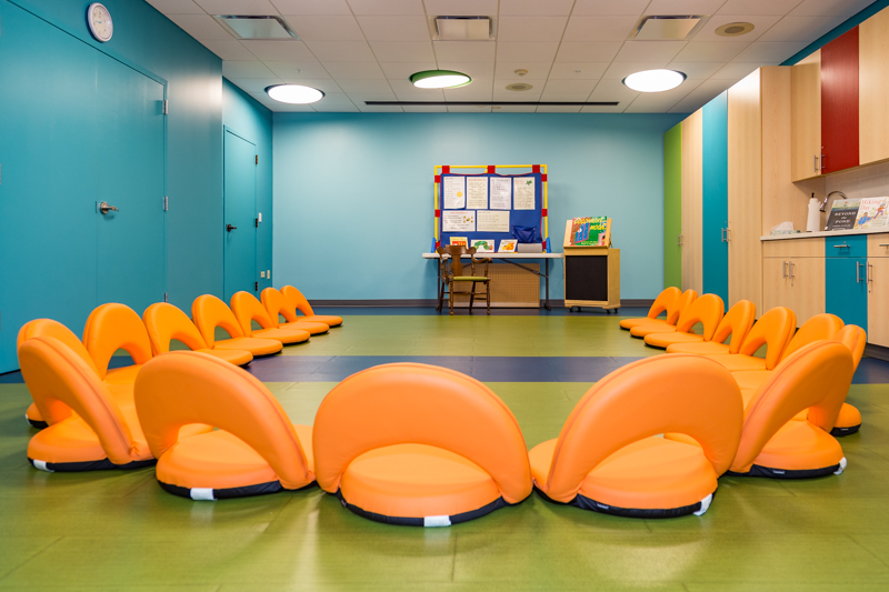 Storytime Room with orange chairs and blue walls