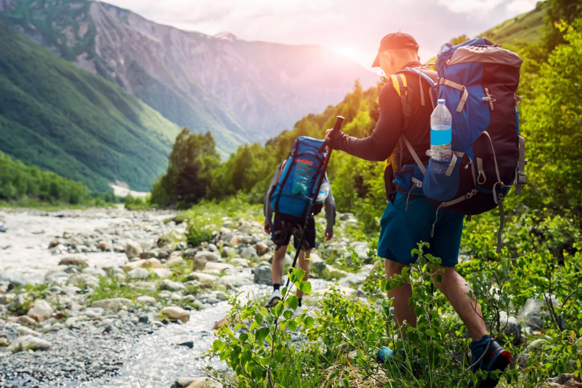 Hikers backpacking through a mountain landscape